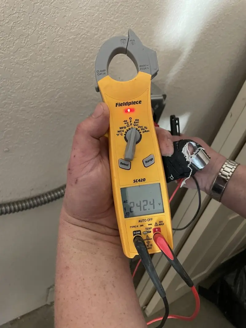 Voltage testing with clamp meter during Recessed Lighting Installation in Tuscola